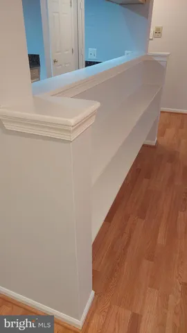 a kitchen with stainless steel appliances granite countertop a refrigerator a stove and a sink with wooden floor