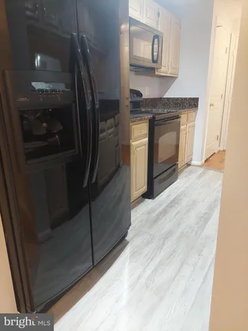 a kitchen with granite countertop a sink and cabinets