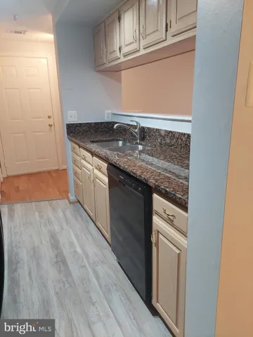a kitchen with stainless steel appliances granite countertop a refrigerator and a stove