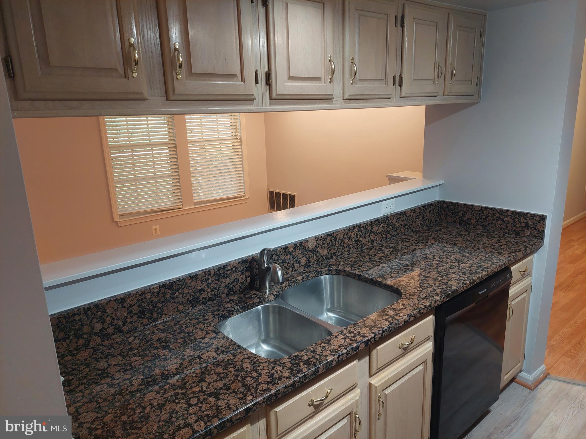 13107 Briarcliff Terrace, Unit 2203 Germantown, MD 20874 - Photo 26 of 53 a kitchen with granite countertop a sink and cabinets