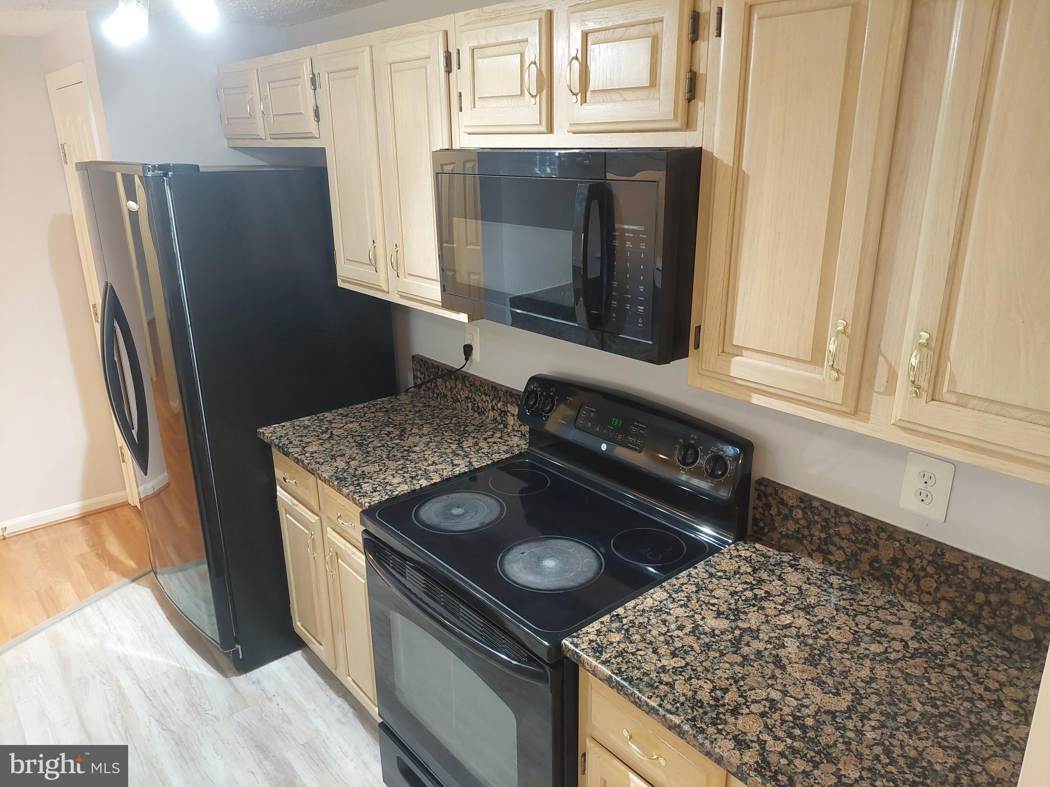 13107 Briarcliff Terrace, Unit 2203 Germantown, MD 20874 - Photo 27 of 53 a kitchen with stainless steel appliances granite countertop a refrigerator and a stove