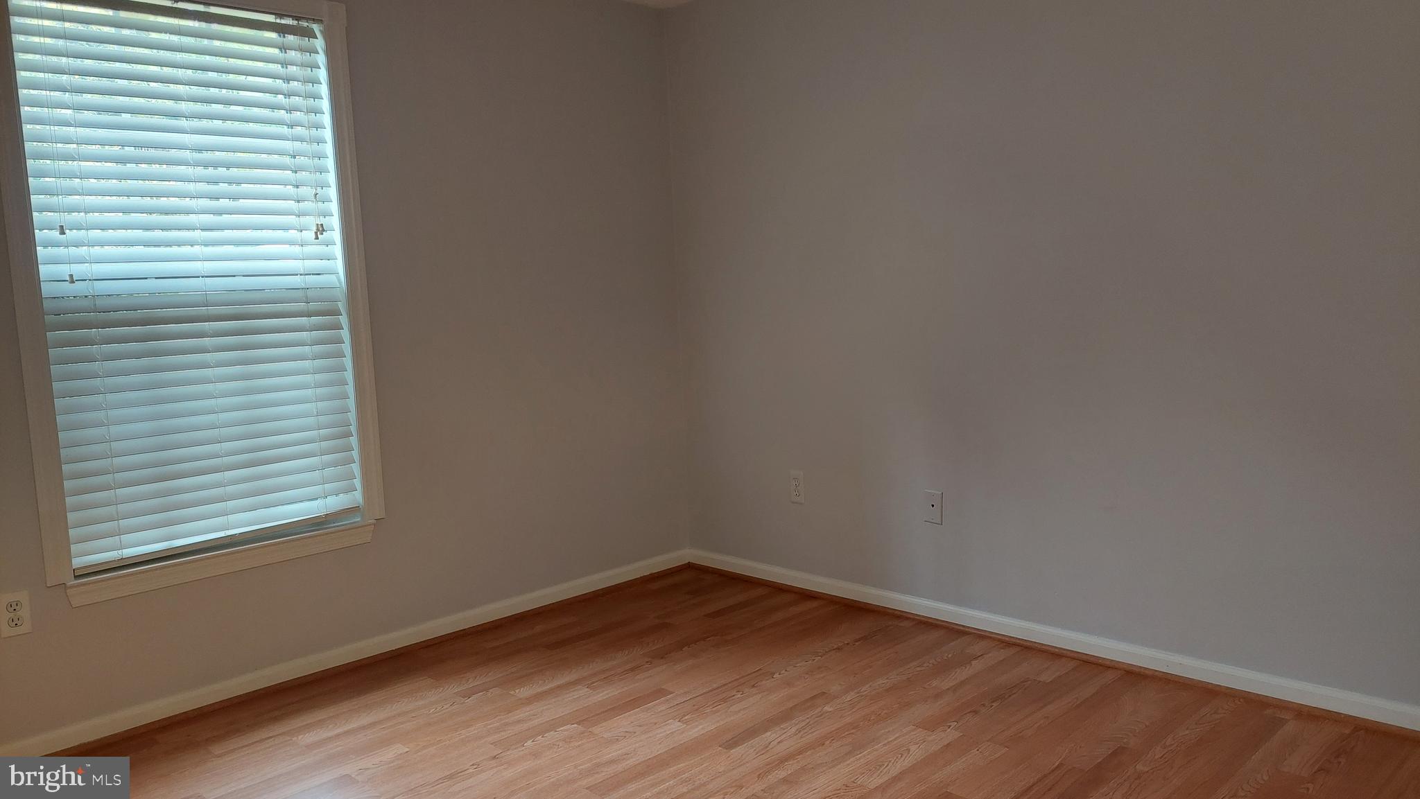 13107 Briarcliff Terrace, Unit 2203 Germantown, MD 20874 - Photo 35 of 53 a view of an empty room with wooden floor and a window