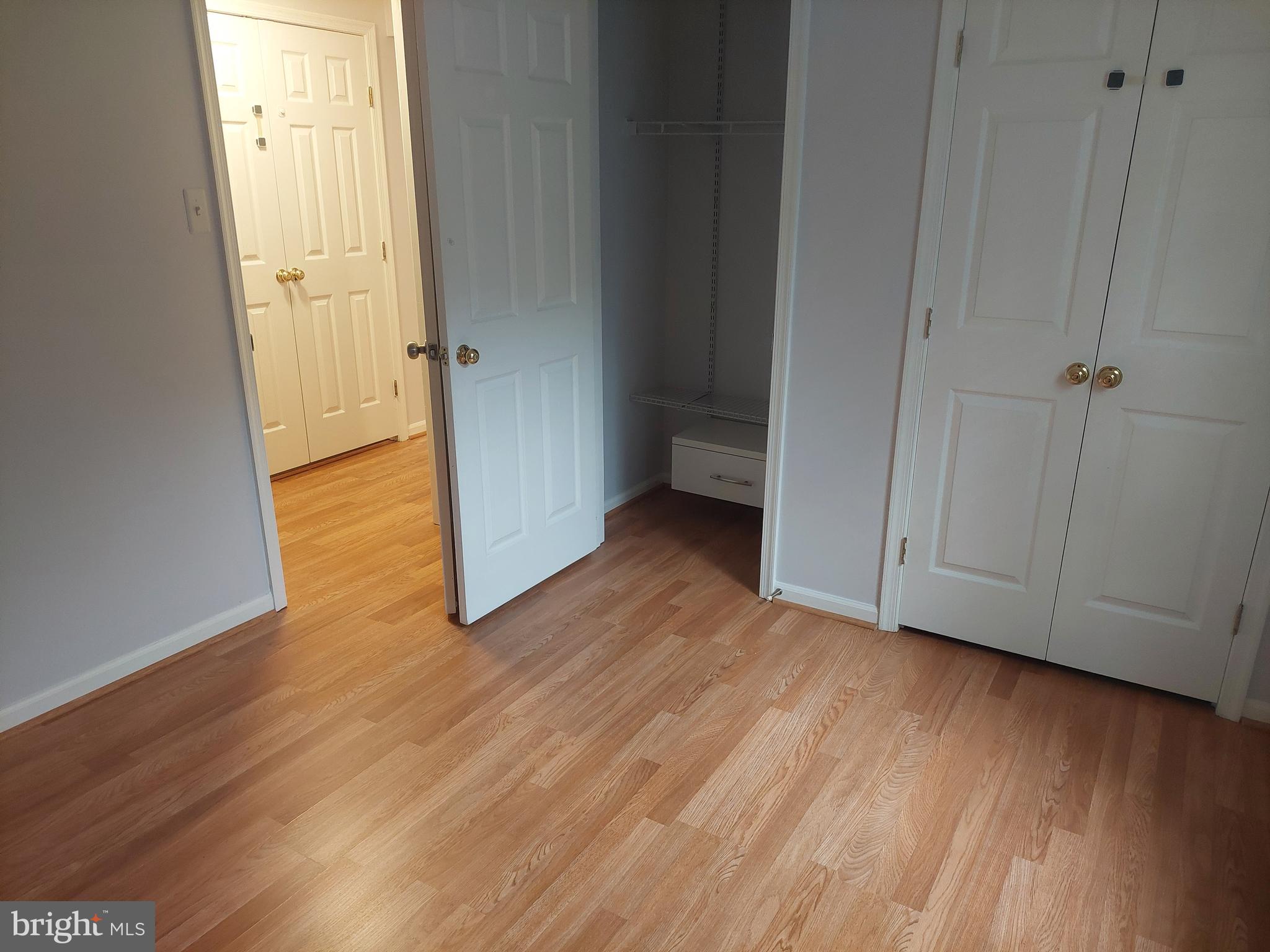 13107 Briarcliff Terrace, Unit 2203 Germantown, MD 20874 - Photo 39 of 53 a view of an empty room with wooden floor and a window