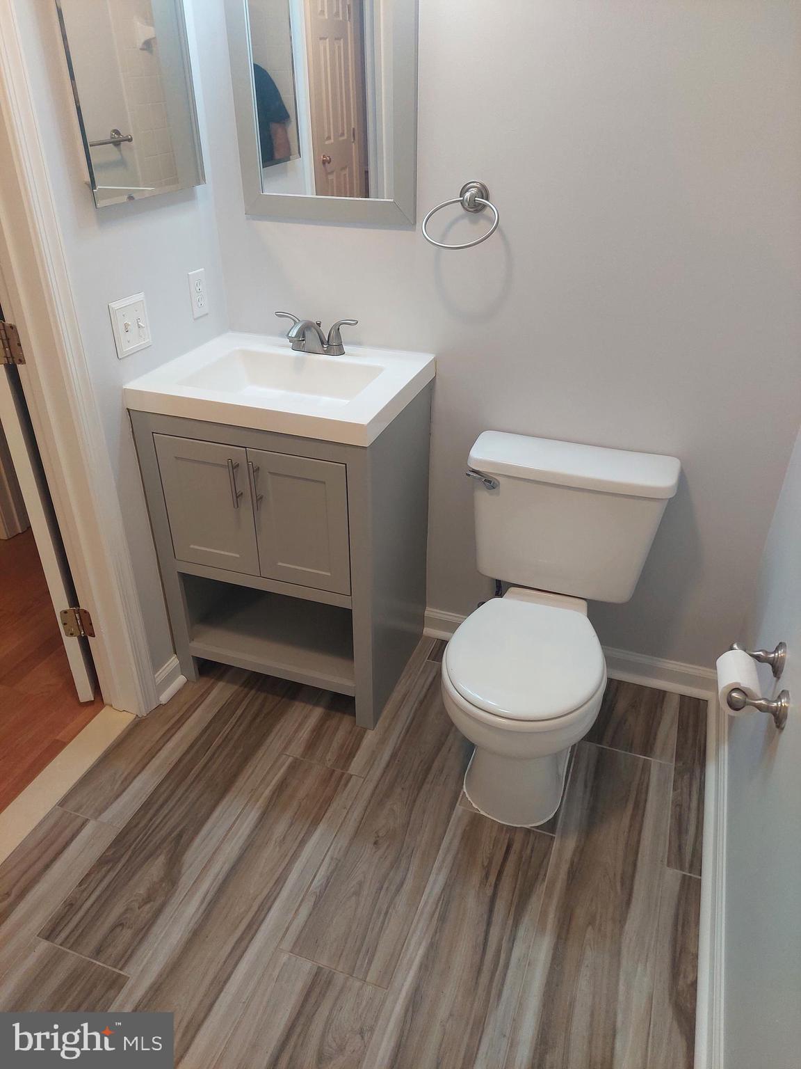 13107 Briarcliff Terrace, Unit 2203 Germantown, MD 20874 - Photo 44 of 53 a bathroom with a toilet sink and mirror