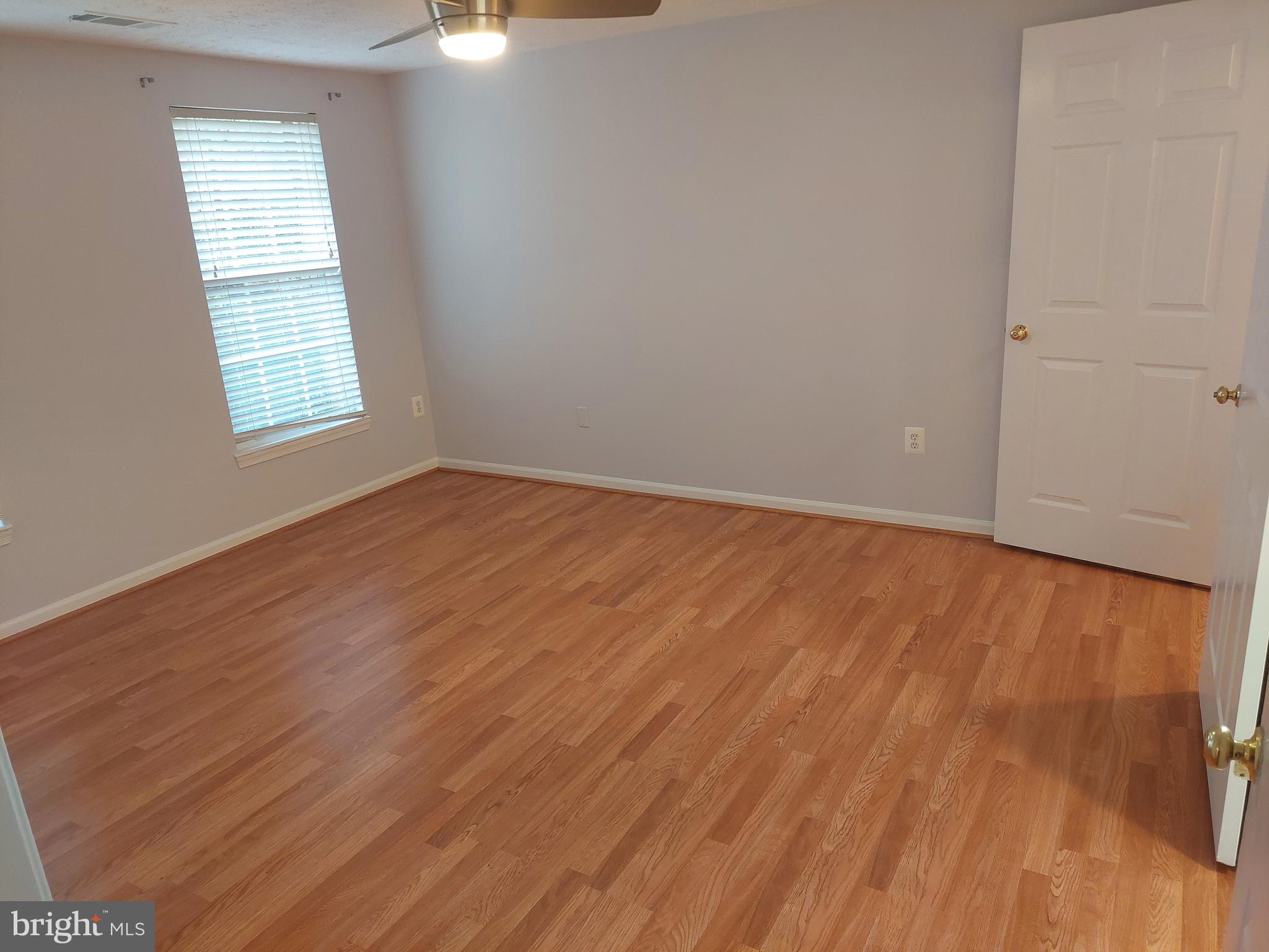 13107 Briarcliff Terrace, Unit 2203 Germantown, MD 20874 - Photo 48 of 53 an empty room with wooden floor cabinet and windows