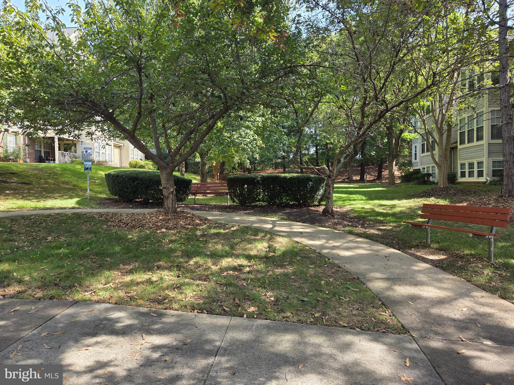 13107 Briarcliff Terrace, Unit 2203 Germantown, MD 20874 - Photo 51 of 53 a view of a garden with a bench and trees
