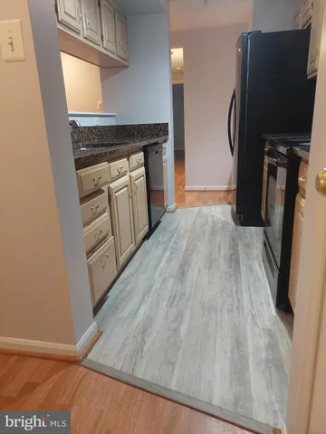a kitchen with wooden floors and a stove