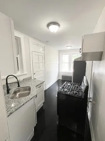 a kitchen with sink refrigerator and stove