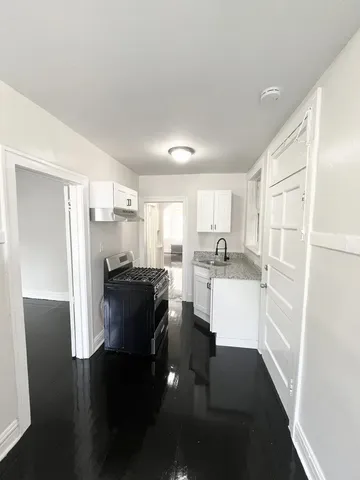 a kitchen with a refrigerator and a sink