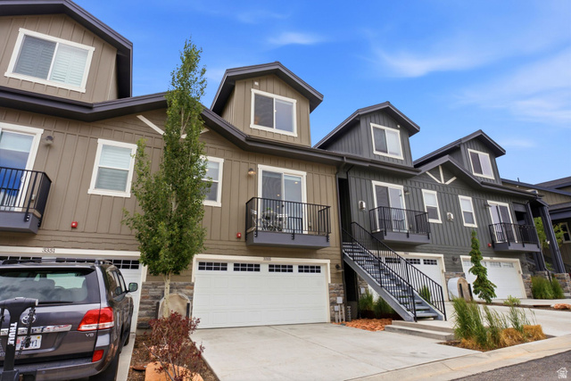 3355 Santa Fe Road Park City, UT 84098 - Photo 30 of 45 Modern townhome exterior featuring contemporary siding, individual garages, private balconies with black railings, dormer windows, and a dedicated exterior staircase