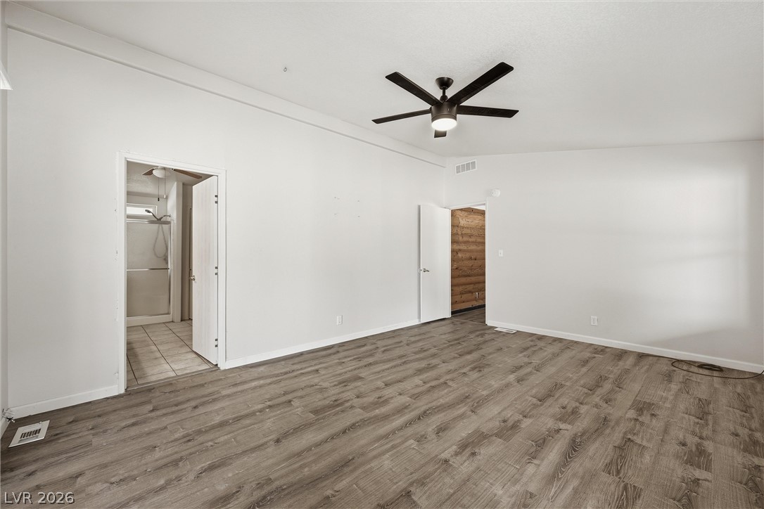 1531 West Harris Farm Road Pahrump, NV 89060 - Photo 24 of 37 A generously proportioned primary bedroom features durable flooring and a refreshing ceiling fan.