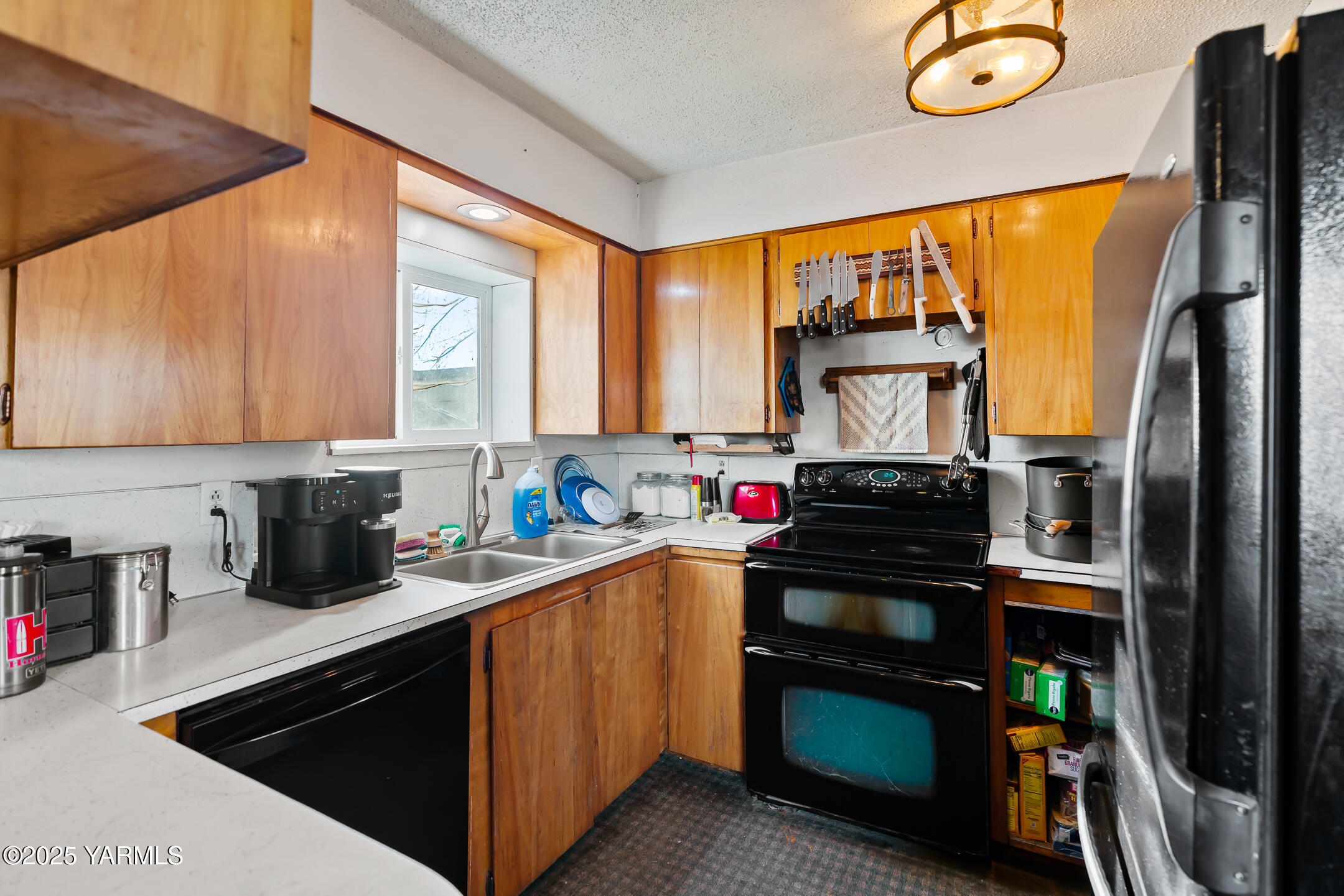1803 Riverside Road Yakima, WA 98901 - Photo 25 of 53 a kitchen with stainless steel appliances a stove refrigerator sink and cabinets