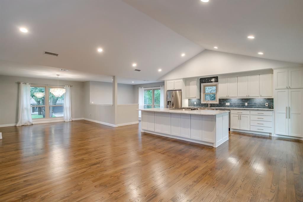 6336 Inca Road Fort Worth, TX 76116 - Photo 11 of 39 a view of kitchen with kitchen island granite countertop wooden floors and wide window