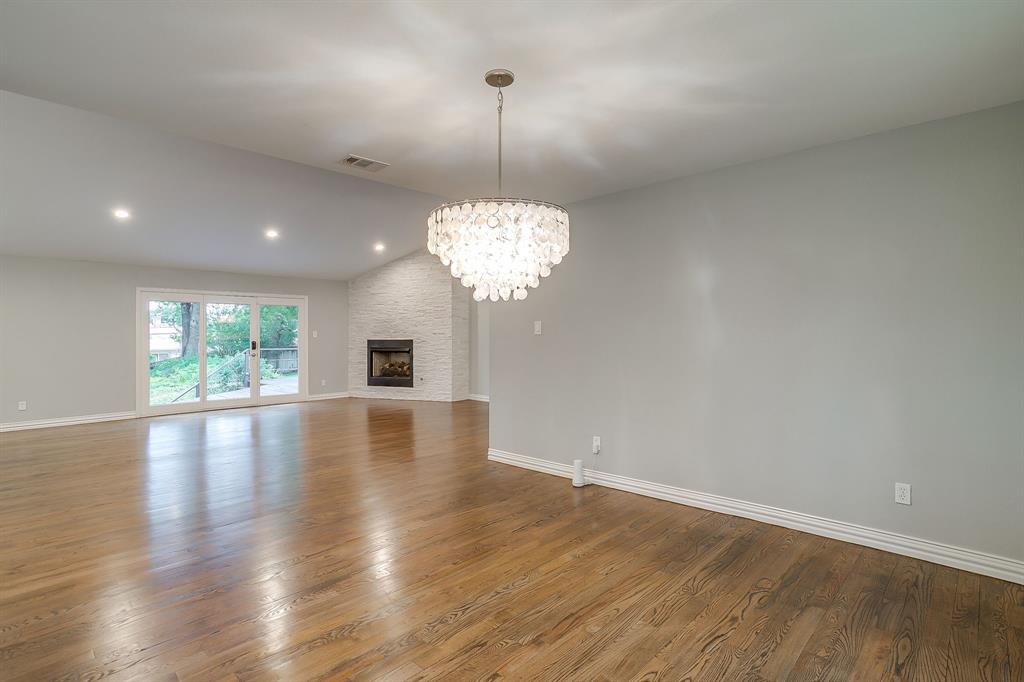 6336 Inca Road Fort Worth, TX 76116 - Photo 16 of 39 a view of a room with wooden floor fireplace and windows