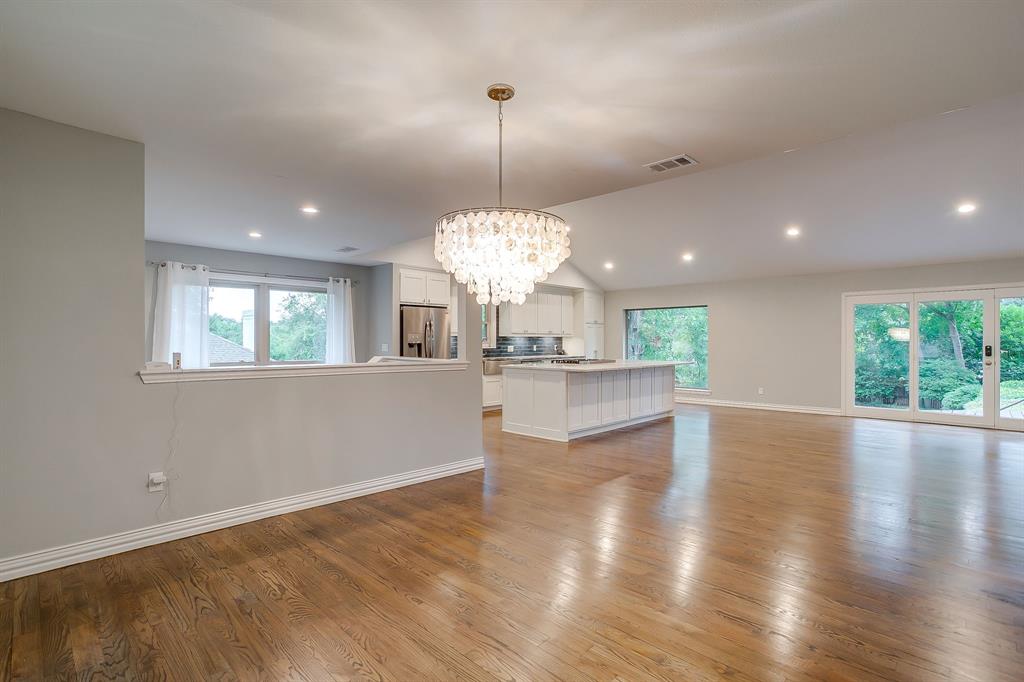 6336 Inca Road Fort Worth, TX 76116 - Photo 17 of 39 a view of a kitchen with granite countertop wooden floor and a chandelier