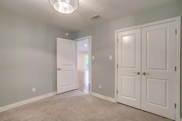 a view of an empty room and closet area