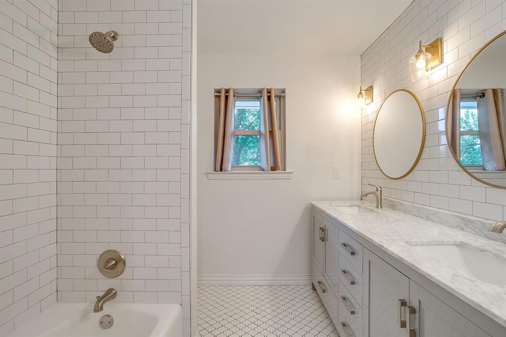 6336 Inca Road Fort Worth, TX 76116 - Photo 20 of 39 a bathroom with a sink mirror and a shower