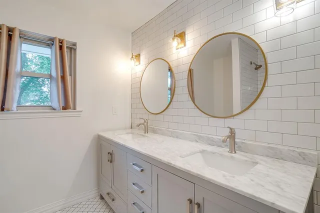 a bathroom with a double vanity sink and a mirror
