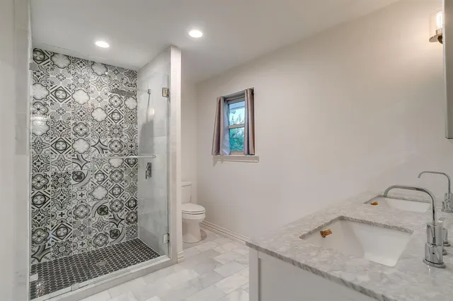 a bathroom with a sink toilet and shower