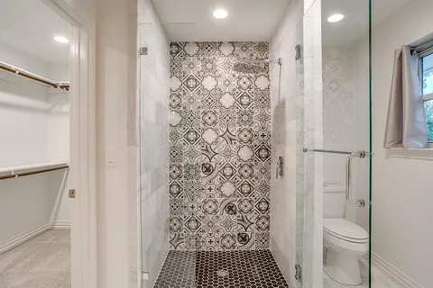 a bathroom with a shower curtain and a toilet