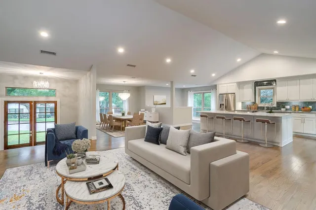 a living room with furniture and a wooden floor