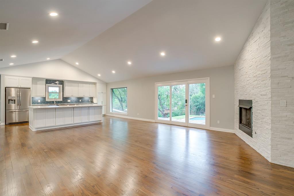 6336 Inca Road Fort Worth, TX 76116 - Photo 6 of 39 a view of an empty room with a kitchen counter top and a fireplace