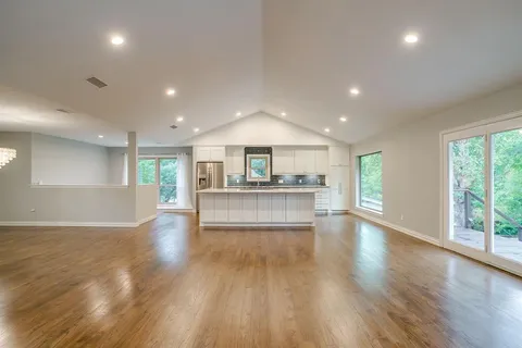 a view of kitchen and kitchen with large windows