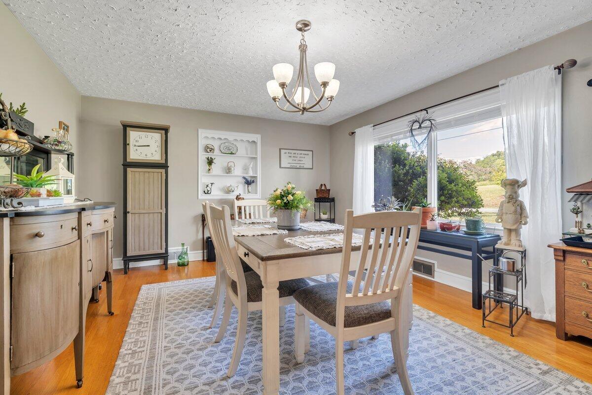 3226 Rakes Road Rocky Mount, VA 24151 - Photo 27 of 74 a view of a dining room with furniture window and wooden floor