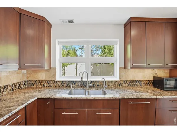 a kitchen with kitchen island a sink stainless steel appliances and cabinets