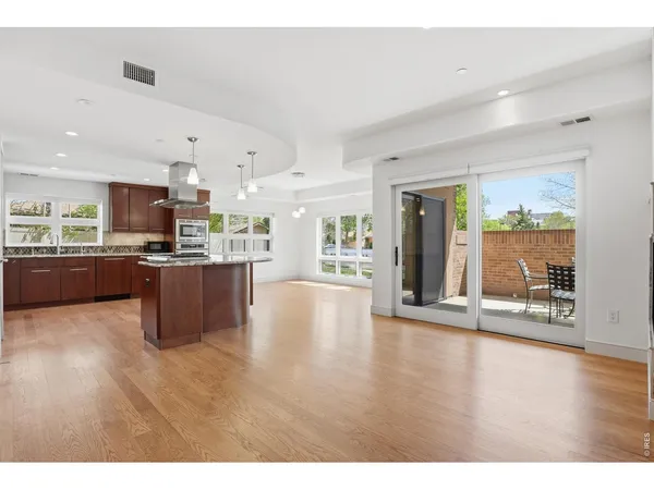 a view of a kitchen with a sink and a large window