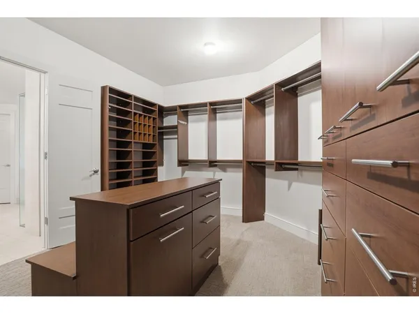 a kitchen view with cabinets and a refrigerator