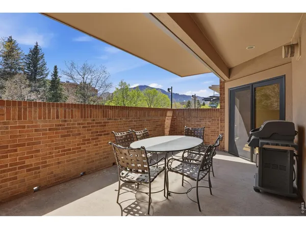 a patio with table and chairs
