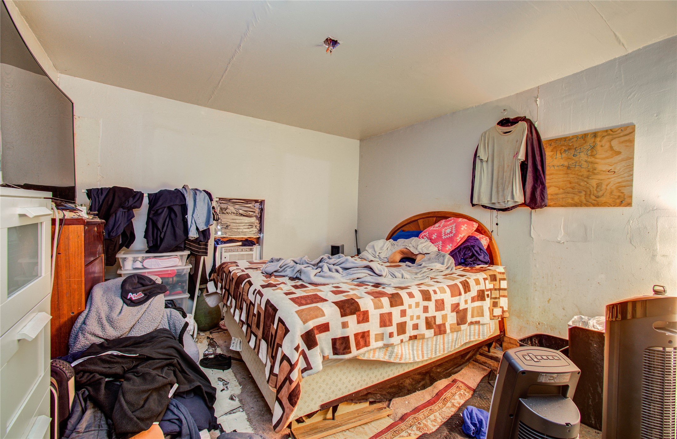 10038 Bamboo Road Houston, TX 77041 - Photo 17 of 36 a bedroom with a bed and dresser with cabinets