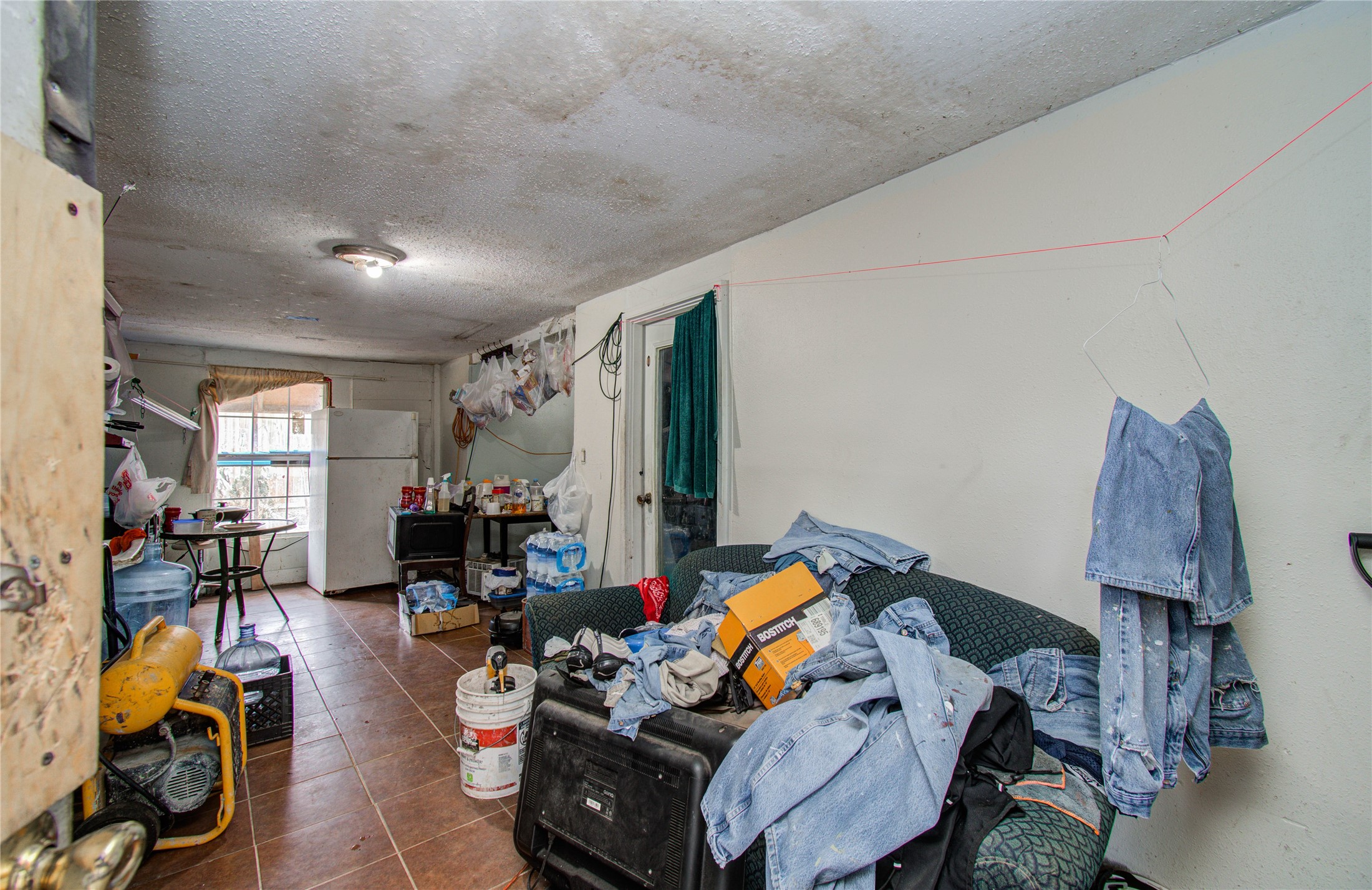 10038 Bamboo Road Houston, TX 77041 - Photo 24 of 36 a living room with furniture a window and gym equipment