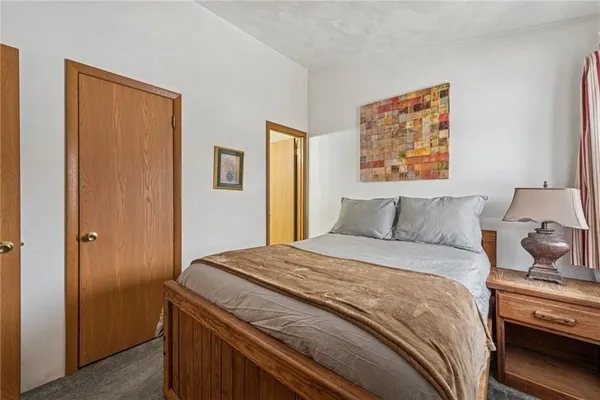 a bedroom with bed and cupboard