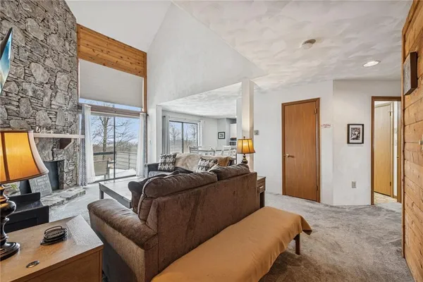 a living room with furniture a large window and flat screen tv