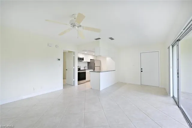 a view of a kitchen with wooden cabinet and stainless steel appliances