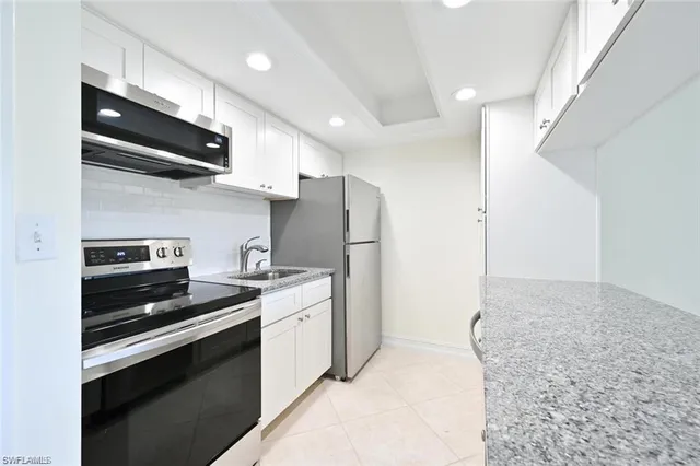 a kitchen with stainless steel appliances a sink stove and refrigerator