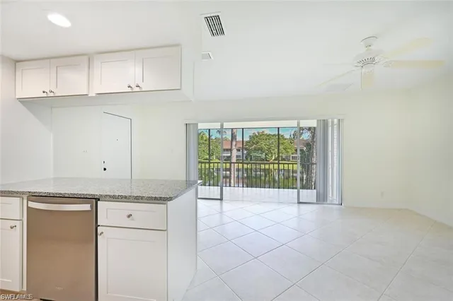 a view of a kitchen with a sink and cabinets