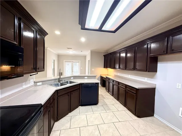 a kitchen with a sink and cabinets