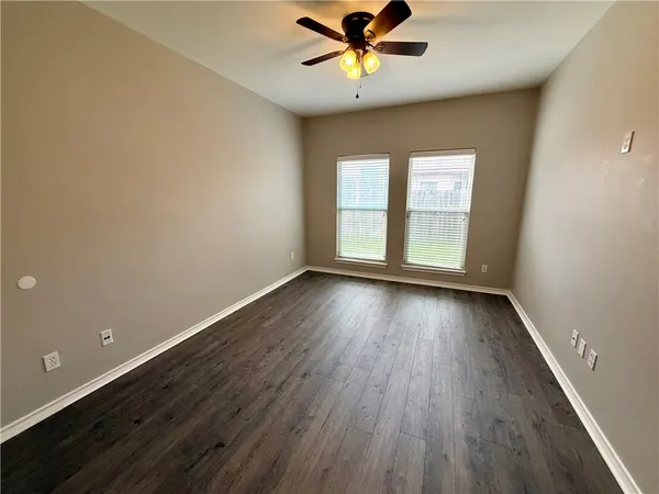 a utility room with granite countertop a sink a stove and washer