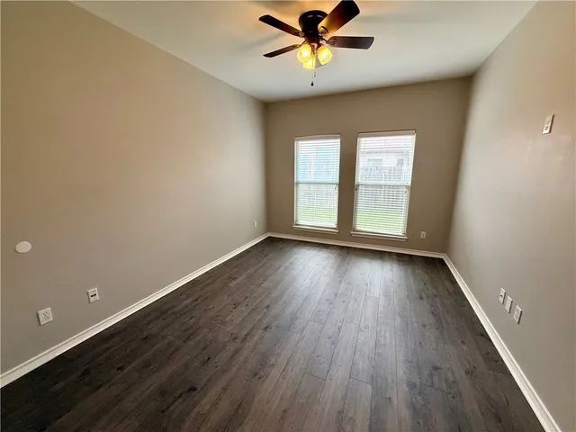 a utility room with granite countertop a sink a stove and washer