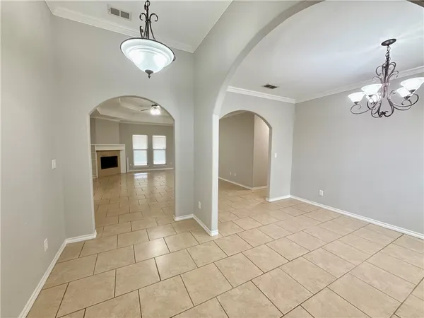 an empty room with wooden floor and mirror