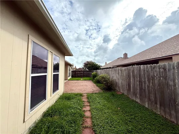 a view of a room with window and wooden floor