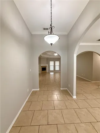 a view of a room with a chandelier and entryway
