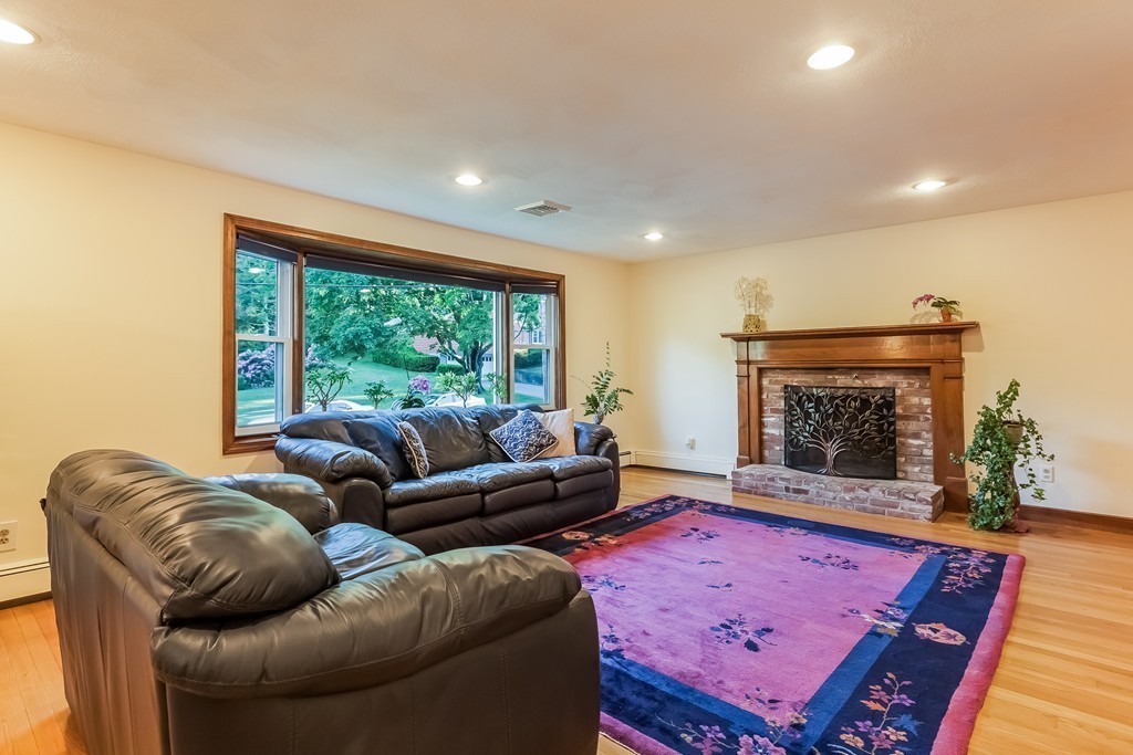 13 Notre Dame Road Acton, MA 01720 - Photo 9 of 28 a living room with furniture a rug and a fireplace