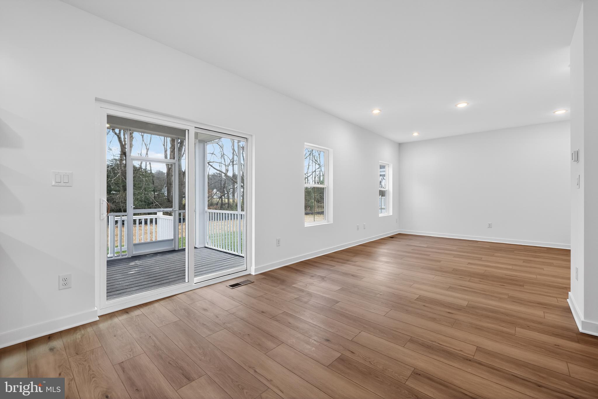 14956 Channel Run Ellendale, DE 19941 - Photo 11 of 28 a view of empty room with wooden floor and fan