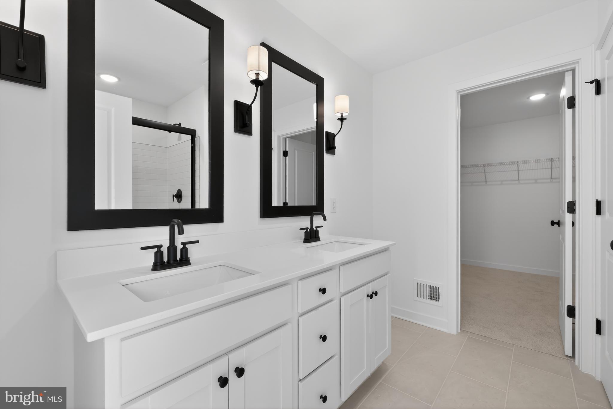 14956 Channel Run Ellendale, DE 19941 - Photo 19 of 28 a bathroom with double vanity sinks and a mirror