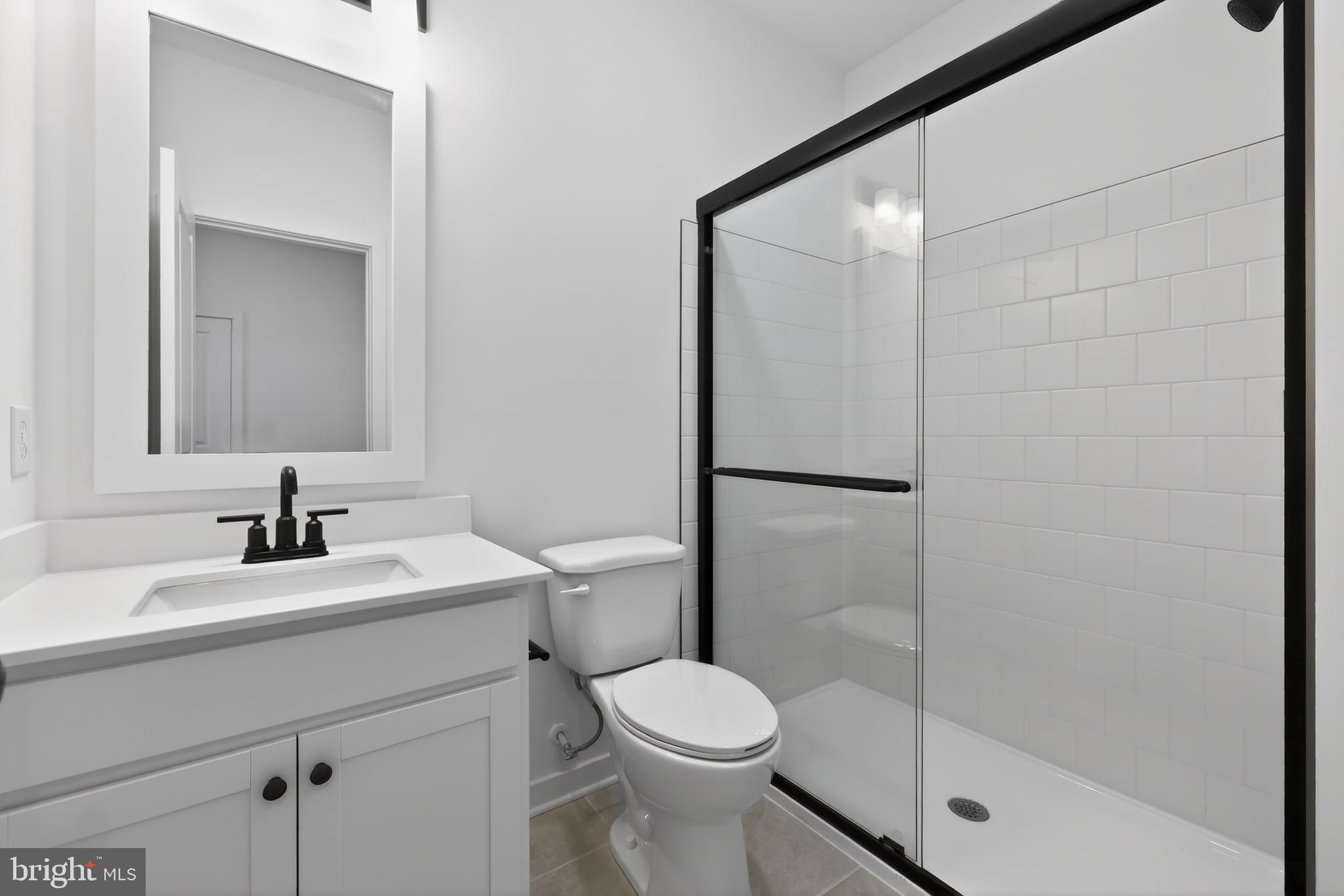 14956 Channel Run Ellendale, DE 19941 - Photo 22 of 28 a bathroom with a sink toilet and shower