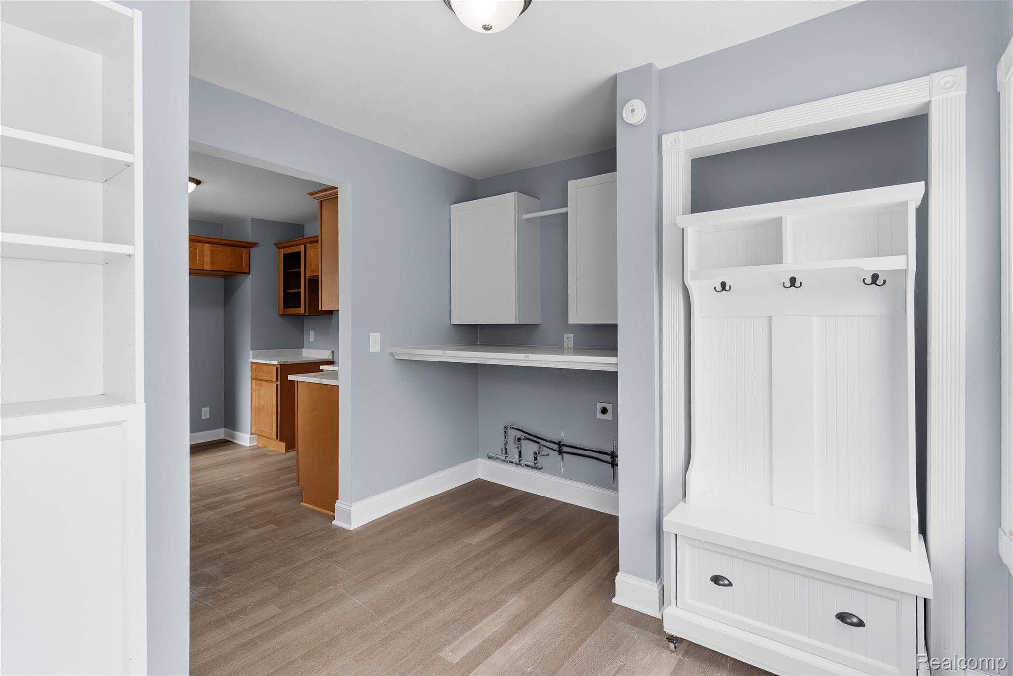 3241 East Frances Road Clio, MI 48420 - Photo 11 of 32 Entryway featuring a built-in white hall tree with storage, hooks, and shelving